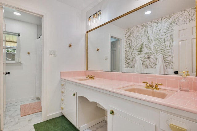 915 Timber Cove Dr, Seabrook, TX 77586 - bathroom featuring marble look tile flooring, double vanity, recessed lighting, and baseboards