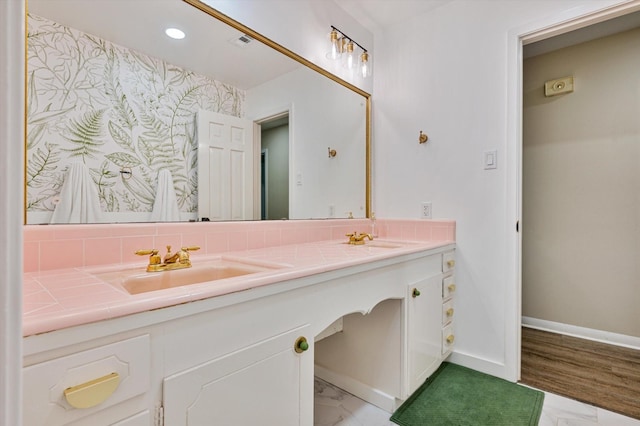 915 Timber Cove Dr, Seabrook, TX 77586 - full bathroom featuring double vanity, baseboards, recessed lighting, decorative backsplash, and marble look tile flooring