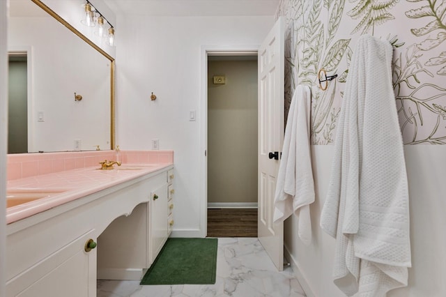 915 Timber Cove Dr, Seabrook, TX 77586 - full bathroom featuring marble look tiles, double vanity, and baseboards