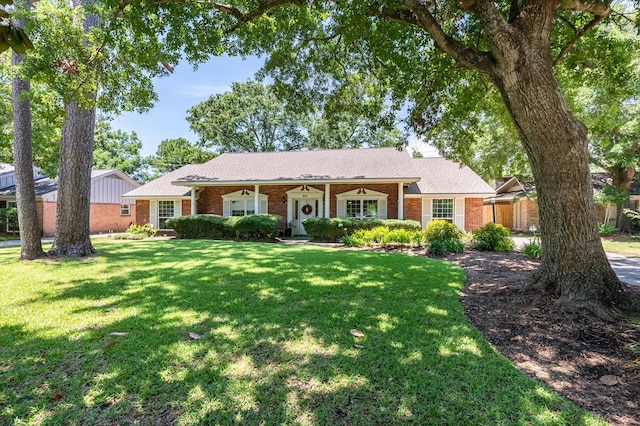915 Timber Cove Dr, Seabrook, TX 77586 - ranch-style house featuring brick siding and a front lawn