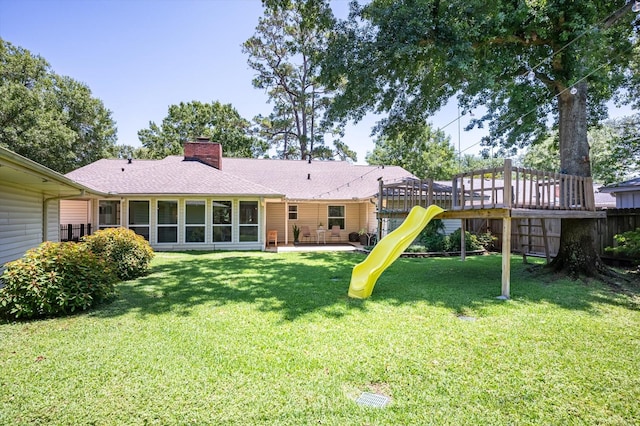 915 Timber Cove Dr, Seabrook, TX 77586 - rear view of house with a playground, a chimney, a patio area, and roof with shingles