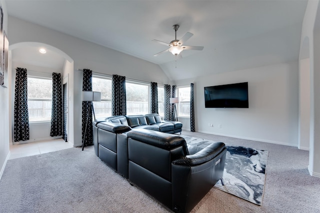 6734 Camden Valley Ct, Houston, TX 77084 - living room with light colored carpet, arched walkways, a ceiling fan, vaulted ceiling, and baseboards