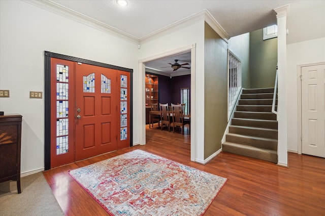 1112 Jackson Blvd, Houston, TX 77006 - entryway with crown molding, wood finished floors, stairway, ceiling fan, and baseboards