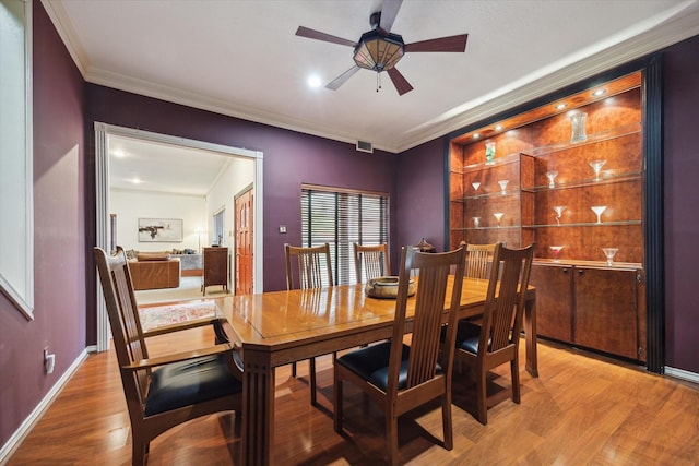 1112 Jackson Blvd, Houston, TX 77006 - dining area featuring ornamental molding, a ceiling fan, wood finished floors, and baseboards