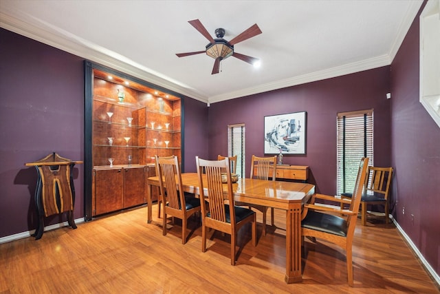 1112 Jackson Blvd, Houston, TX 77006 - dining area featuring light wood-type flooring, ceiling fan, crown molding, and baseboards