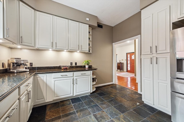 1112 Jackson Blvd, Houston, TX 77006 - kitchen with open shelves, stainless steel refrigerator with ice dispenser, dark stone finish flooring, and white cabinets