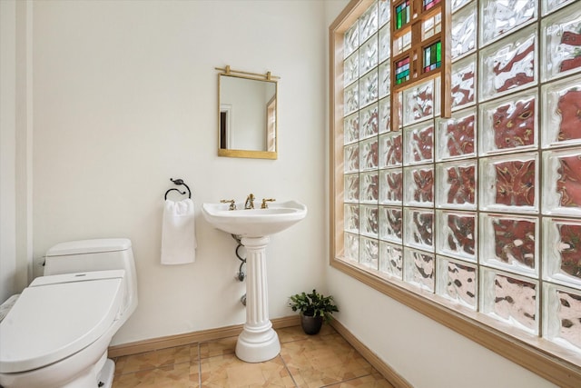 1112 Jackson Blvd, Houston, TX 77006 - bathroom featuring toilet, baseboards, and tile patterned flooring