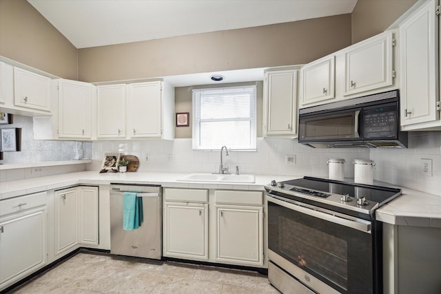 1112 Jackson Blvd, Houston, TX 77006 - kitchen with appliances with stainless steel finishes, a sink, tile countertops, and decorative backsplash