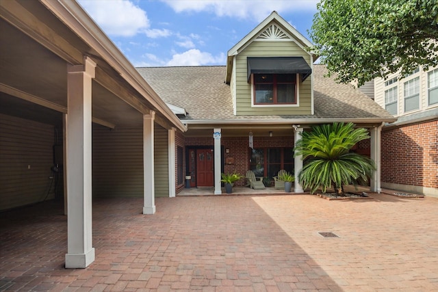 1112 Jackson Blvd, Houston, TX 77006 - view of front of home with a shingled roof, brick siding, and a porch