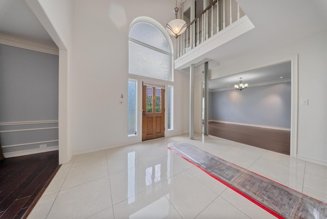 1818 Hillgreen Dr, Katy, TX 77494 - foyer featuring crown molding, a chandelier, baseboards, a high ceiling, and tile patterned floors