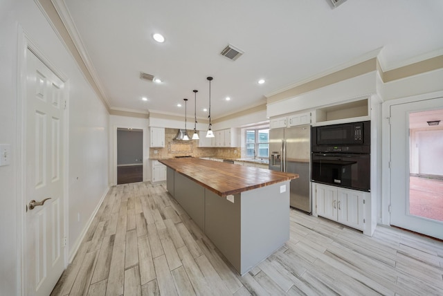 1818 Hillgreen Dr, Katy, TX 77494 - kitchen with wooden counters, black appliances, white cabinets, a kitchen island, and ornamental molding