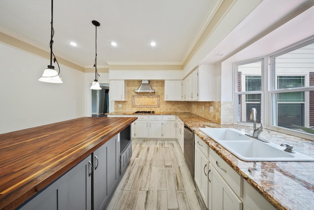 1818 Hillgreen Dr, Katy, TX 77494 - kitchen featuring butcher block countertops, a sink, wall chimney exhaust hood, white cabinets, and light wood-style flooring