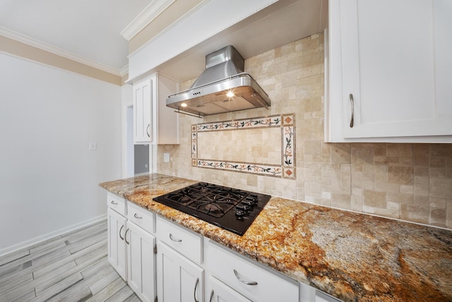 1818 Hillgreen Dr, Katy, TX 77494 - kitchen with wall chimney range hood, black gas stovetop, crown molding, light stone counters, and white cabinetry