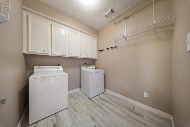 1818 Hillgreen Dr, Katy, TX 77494 - laundry room featuring washer and clothes dryer, cabinet space, light wood-type flooring, and baseboards