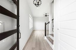 6418 Bolinas Ct, Rosharon, TX 77583 - corridor featuring baseboards, light wood-type flooring, and a chandelier