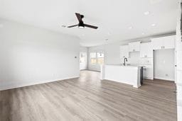 6418 Bolinas Ct, Rosharon, TX 77583 - unfurnished living room with a ceiling fan, wood finished floors, and baseboards