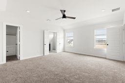 6418 Bolinas Ct, Rosharon, TX 77583 - unfurnished bedroom featuring carpet floors, a walk in closet, baseboards, and lofted ceiling