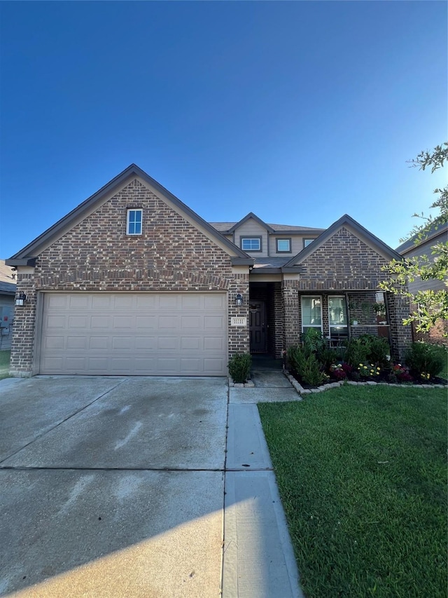 11111 Grape Hyacinth Ln, Houston, TX 77044 - traditional-style house featuring brick siding, concrete driveway, a garage, and a front lawn