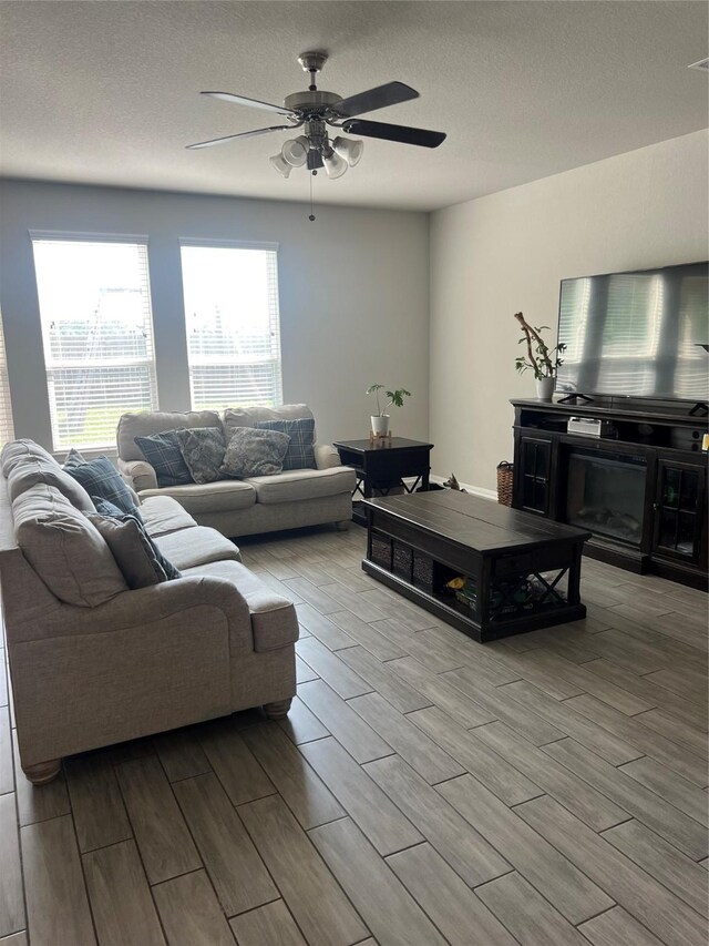11111 Grape Hyacinth Ln, Houston, TX 77044 - living area featuring wood tiled floors, ceiling fan, and a textured ceiling