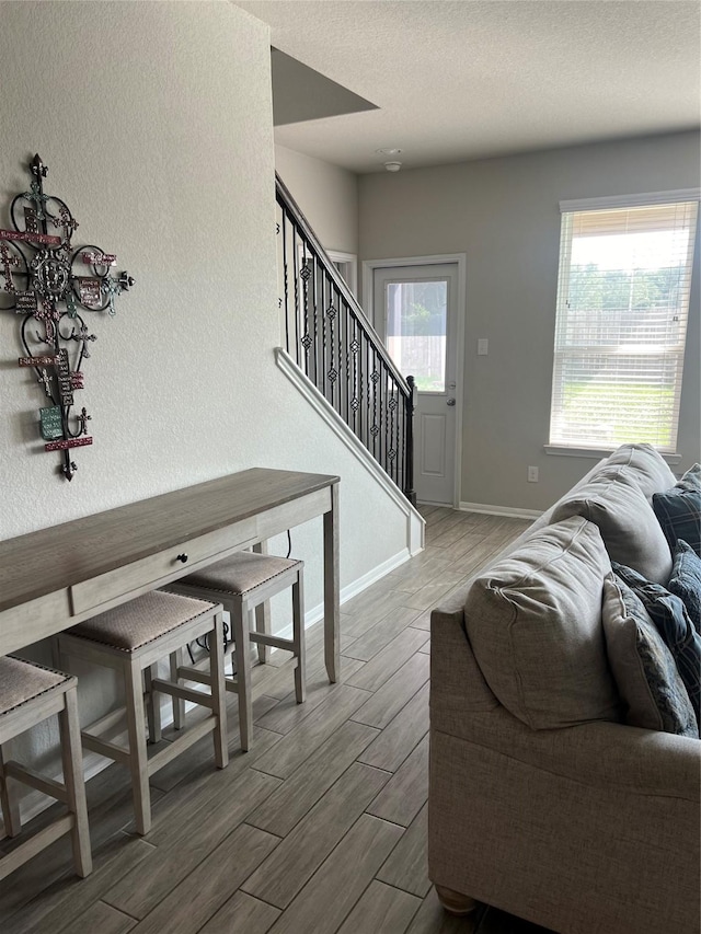 11111 Grape Hyacinth Ln, Houston, TX 77044 - living area with wood finish floors, baseboards, and stairs