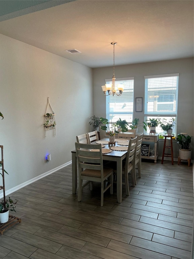 11111 Grape Hyacinth Ln, Houston, TX 77044 - dining space with a chandelier, dark wood-style floors, and baseboards