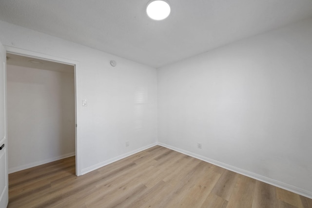 700 Lyle W Ave Unit B, Cleveland, TX 77327 - empty room with light wood-type flooring and baseboards