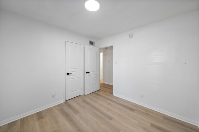 700 Lyle W Ave Unit B, Cleveland, TX 77327 - unfurnished bedroom featuring light wood-style floors and baseboards