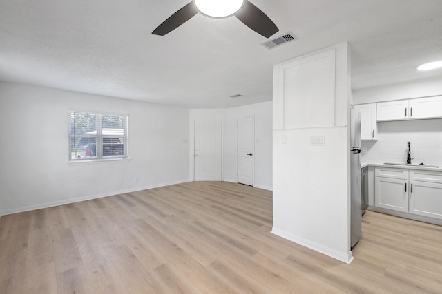 700 Lyle W Ave Unit B, Cleveland, TX 77327 - unfurnished living room with a sink, a ceiling fan, light wood-style floors, and baseboards