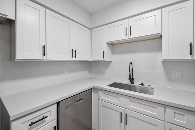 700 Lyle W Ave Unit B, Cleveland, TX 77327 - kitchen with stainless steel dishwasher, a sink, tasteful backsplash, and white cabinetry