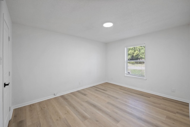 700 Lyle W Ave Unit B, Cleveland, TX 77327 - empty room with light wood finished floors and baseboards