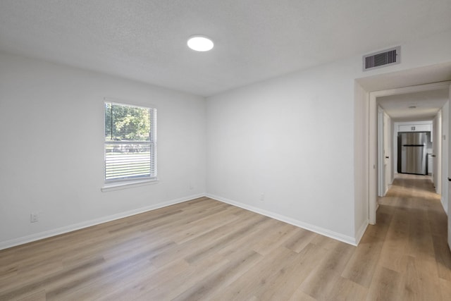 700 Lyle W Ave Unit B, Cleveland, TX 77327 - spare room with light wood-style flooring and baseboards
