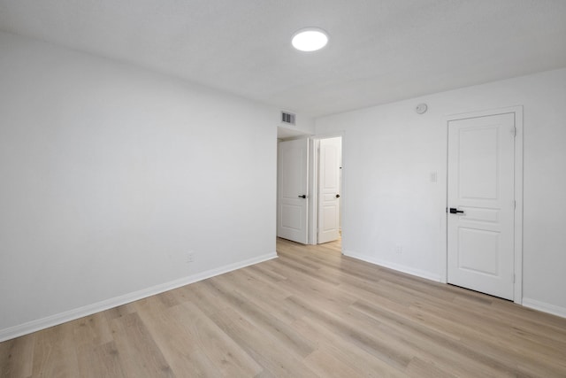 700 Lyle W Ave Unit B, Cleveland, TX 77327 - empty room with light wood-style flooring and baseboards
