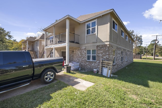 700 Lyle W Ave Unit B, Cleveland, TX 77327 - view of home's exterior with a yard, a balcony, brick siding, and stairway