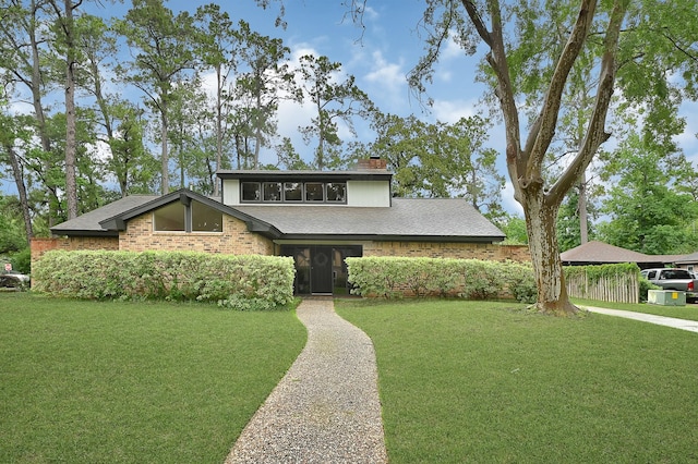 2003 Hidden Creek Dr, Houston, TX 77339 - mid-century modern home with a chimney and roof with shingles