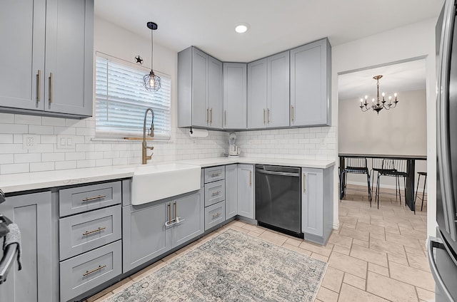 2003 Hidden Creek Dr, Houston, TX 77339 - kitchen with stainless steel appliances, gray cabinetry, a sink, backsplash, and a chandelier