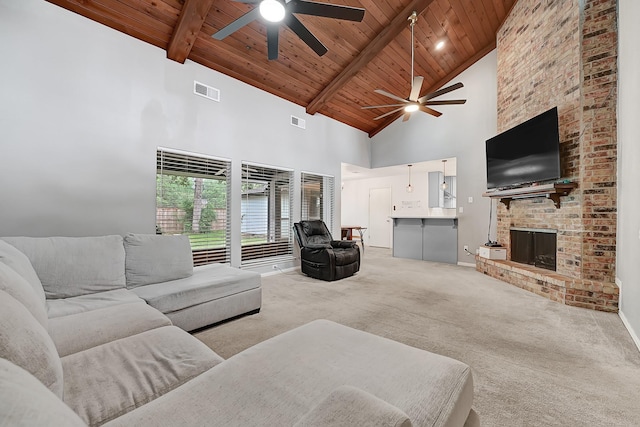 2003 Hidden Creek Dr, Houston, TX 77339 - carpeted living room with a ceiling fan, wood ceiling with exposed beams, high vaulted ceiling, baseboards, and a brick fireplace