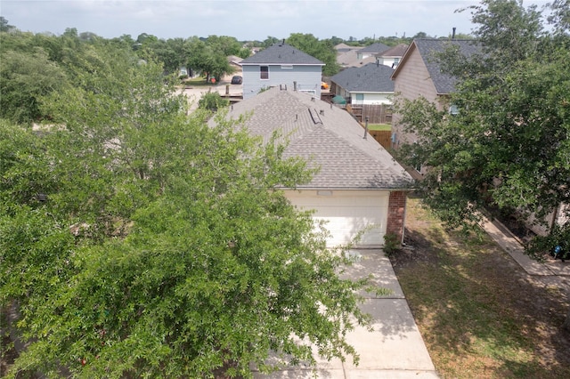 12903 Belmont Legend Ct, Houston, TX 77047 - view of side of property with brick siding, a garage, and roof with shingles