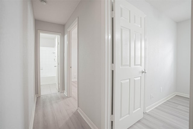 12903 Belmont Legend Ct, Houston, TX 77047 - hallway with light wood-type flooring and baseboards