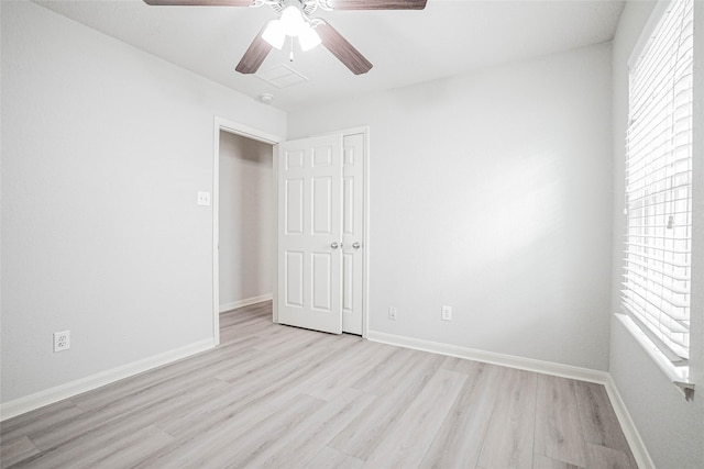 12903 Belmont Legend Ct, Houston, TX 77047 - unfurnished bedroom featuring light wood finished floors, multiple windows, baseboards, and ceiling fan