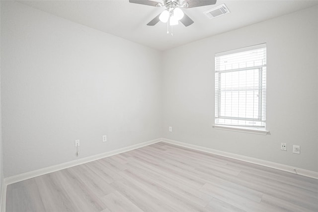 12903 Belmont Legend Ct, Houston, TX 77047 - spare room featuring healthy amount of natural light, light wood-type flooring, ceiling fan, and baseboards