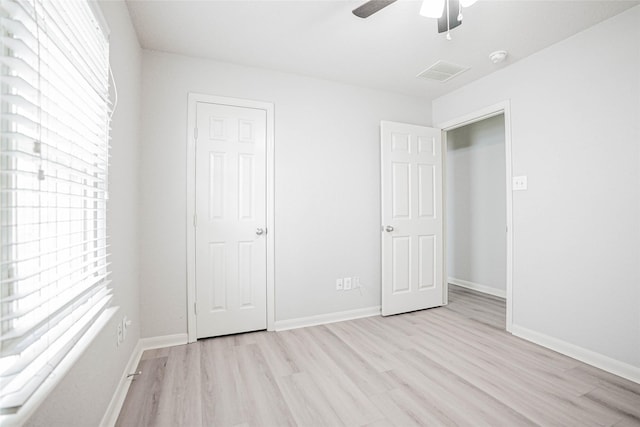 12903 Belmont Legend Ct, Houston, TX 77047 - unfurnished bedroom featuring light wood-style flooring, baseboards, and ceiling fan