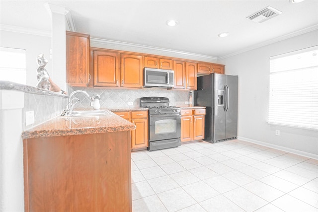 12903 Belmont Legend Ct, Houston, TX 77047 - kitchen with stainless steel microwave, black gas stove, fridge with ice dispenser, a sink, and ornamental molding