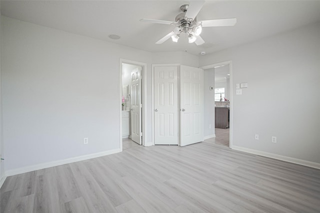 12903 Belmont Legend Ct, Houston, TX 77047 - unfurnished bedroom with light wood finished floors, baseboards, and connected bathroom