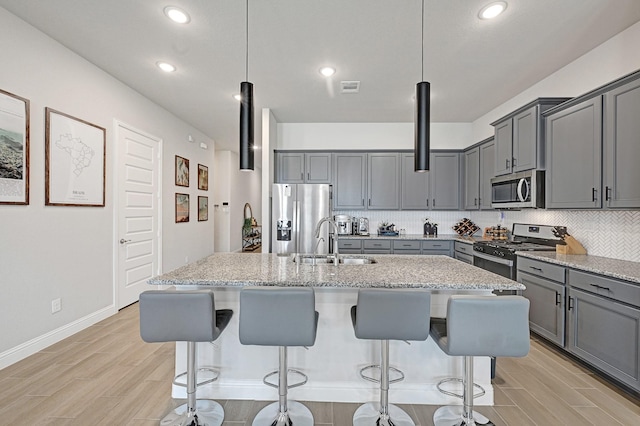 2104 Terra Rose Dr, Katy, TX 77493 - kitchen with stainless steel appliances, gray cabinetry, a sink, and recessed lighting