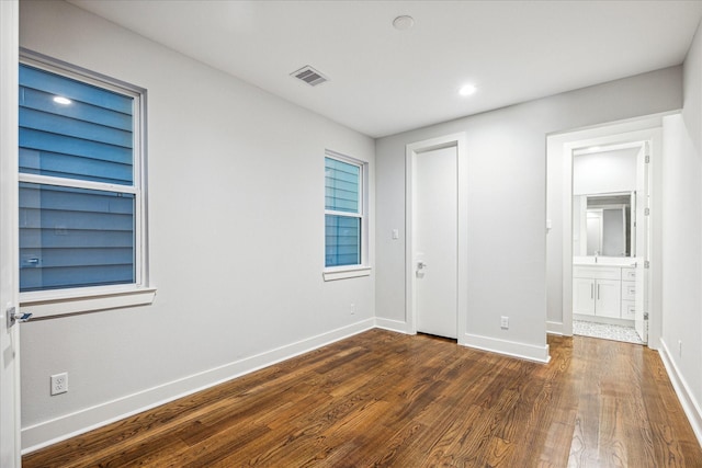 1518 Houston Ave, Houston, TX 77007 - unfurnished bedroom featuring dark wood-style flooring, baseboards, and recessed lighting