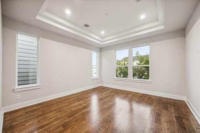 1518 Houston Ave, Houston, TX 77007 - empty room featuring a raised ceiling, dark wood finished floors, recessed lighting, and baseboards