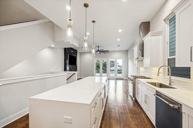 1518 Houston Ave, Houston, TX 77007 - kitchen with stainless steel appliances, a sink, a kitchen island, dark wood-type flooring, and white cabinets