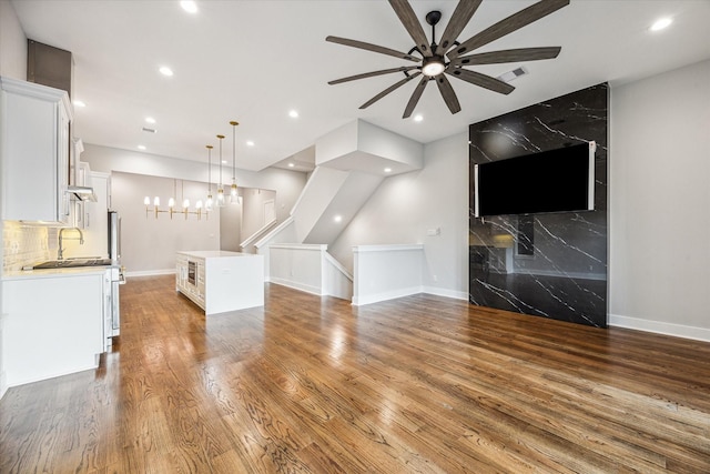 1518 Houston Ave, Houston, TX 77007 - unfurnished living room featuring ceiling fan, wood finished floors, recessed lighting, baseboards, and a sink