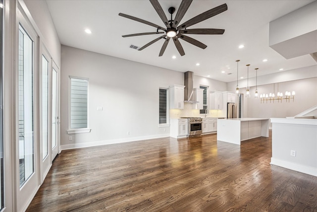 1518 Houston Ave, Houston, TX 77007 - unfurnished living room with a ceiling fan, plenty of natural light, dark wood-type flooring, a chandelier, and recessed lighting