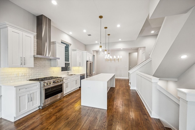 1518 Houston Ave, Houston, TX 77007 - kitchen with high quality appliances, wall chimney exhaust hood, a sink, backsplash, and light countertops